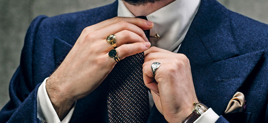 several mens rings on hand